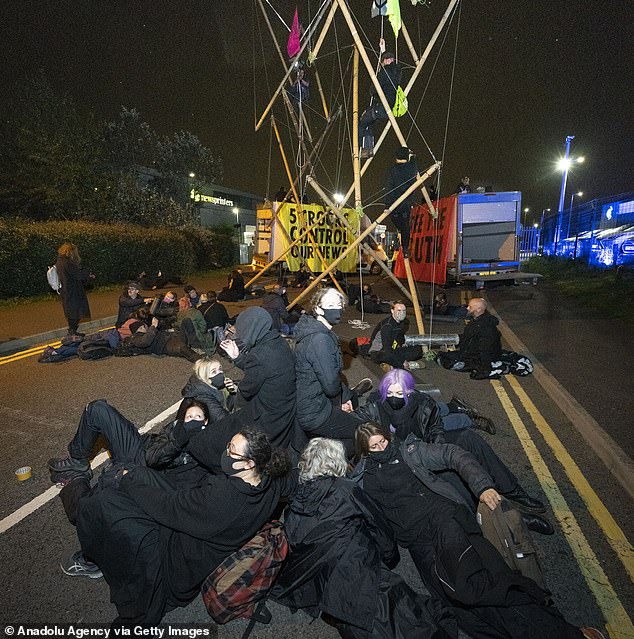 Extinction Rebellion protestors block access of a printing house in Broxbourne, Hertfordshire, leaving some newsagents' shelves empty on Saturday morning
